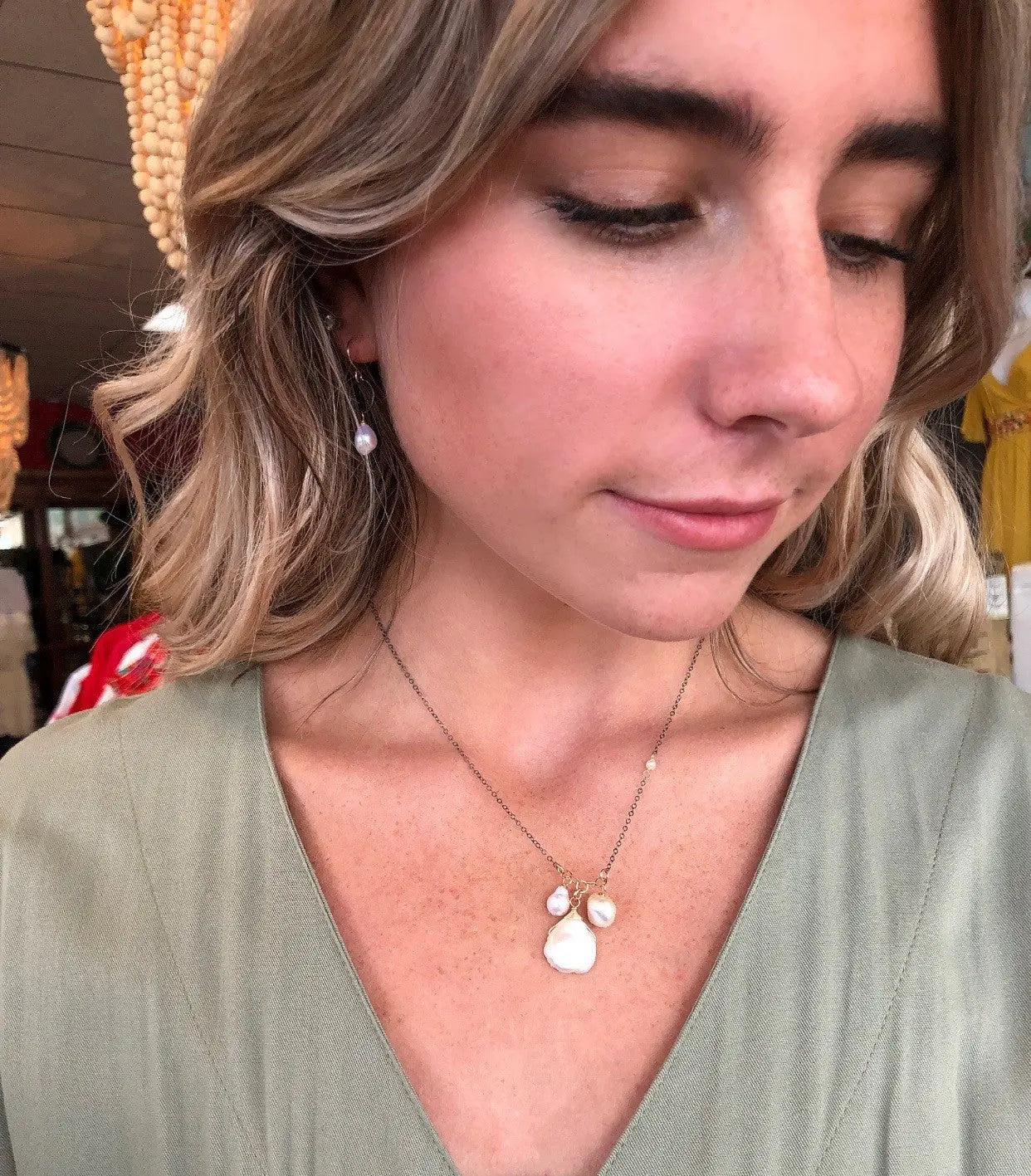 Model wearing 3 pearl necklace in oxidized Sterling silver