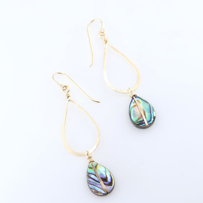 A pair of gold teardrop dangle earrings with iridescent abalone shell drops, displayed on a clean white background.