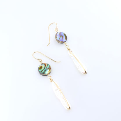 A pair of dangle earrings featuring round, iridescent green and blue Abalone and Biwa Pearl drops, shown on a clean white background.
