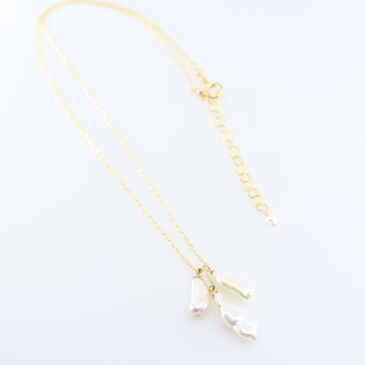A delicate gold chain necklace featuring three small dangling Biwa Pearl charms, displayed on a clean white background.