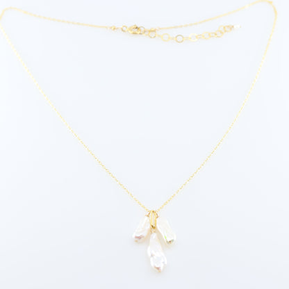 A delicate gold chain necklace featuring three small dangling Biwa Pearl charms, displayed on a clean white background.